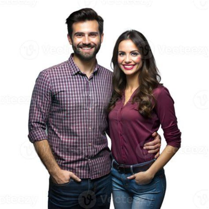 a man and woman standing next to each other on the red carpet at an event