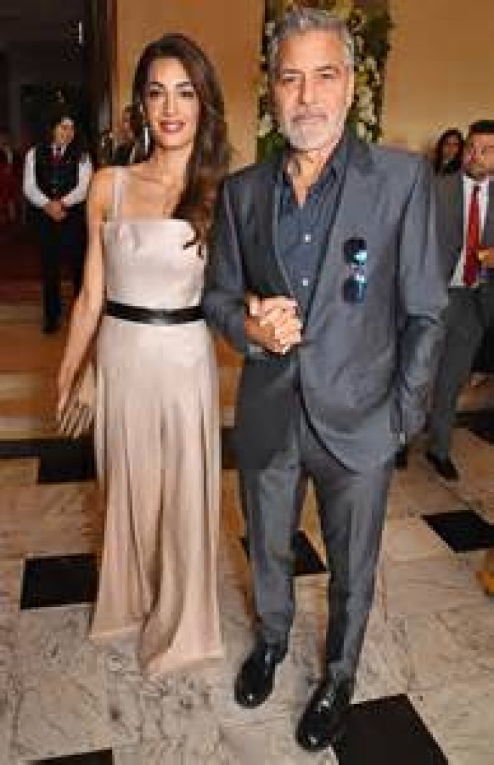 and Amal Clooney Hold Hands for Night Out at The Prince's Trust